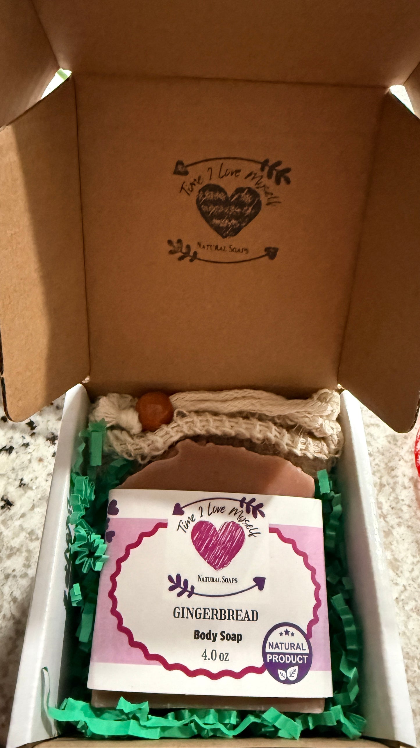 Body soap with a label in a box with a soap mesh bag.